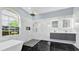 Modern bathroom features a large shower with black and white tile, stand alone tub, and arched window at 1716 Bermuda Ct, Safety Harbor, FL 34695