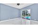 Bright bedroom with sliding doors that lead to a screened-in pool at 1716 Bermuda Ct, Safety Harbor, FL 34695