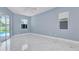 Spacious bedroom with neutral walls, ceramic tile flooring, and natural light at 1716 Bermuda Ct, Safety Harbor, FL 34695