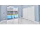 Bright bedroom featuring sliding doors to the pool and a white closet at 1716 Bermuda Ct, Safety Harbor, FL 34695