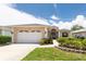 Inviting single-story home with a well-manicured lawn, attached garage, and lovely landscaping at 1716 Bermuda Ct, Safety Harbor, FL 34695