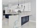 Modern kitchen featuring an island with a blue marble countertop and sleek appliances at 1716 Bermuda Ct, Safety Harbor, FL 34695