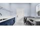 Laundry room features modern washer and dryer with blue cabinetry and white quartz countertops at 1716 Bermuda Ct, Safety Harbor, FL 34695