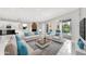 Open-concept living room with modern decor and a view of the outdoor pool area at 1716 Bermuda Ct, Safety Harbor, FL 34695