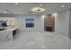 Bright living room features marble floors, modern fireplace with wood accent, and stylish light fixture at 1716 Bermuda Ct, Safety Harbor, FL 34695
