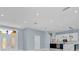 Bright, open-concept living space features a modern kitchen and view of the front entrance at 1716 Bermuda Ct, Safety Harbor, FL 34695