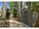 Backyard showing storage buildings, stone pathway, and landscaping at 17906 Loretta Ln, Lutz, FL 33548