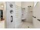 Bathroom featuring a dual shower head, seat, and a glass block window at 17906 Loretta Ln, Lutz, FL 33548