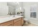 Bright bathroom featuring a light colored vanity, and shutters on the windows at 17906 Loretta Ln, Lutz, FL 33548