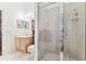 Modern bathroom featuring glass shower enclosure, cabinet vanity, and tile flooring at 17906 Loretta Ln, Lutz, FL 33548