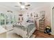 Bedroom featuring a window with plantation shutters, wood-look flooring, and an area rug at 17906 Loretta Ln, Lutz, FL 33548