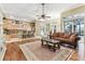 Open-concept living room with kitchen, bar seating, comfortable seating, and access to the outside at 17906 Loretta Ln, Lutz, FL 33548