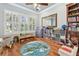 Play room with wood floors, shuttered windows, and a circular map-themed area rug at 17906 Loretta Ln, Lutz, FL 33548