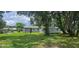 Expansive backyard featuring multiple sheds and an enclosed back porch, plus mature shade trees at 1908 S Kingsway Rd, Seffner, FL 33584