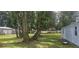 Lush backyard features mature trees and a well-maintained lawn at 1908 S Kingsway Rd, Seffner, FL 33584