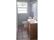 Cozy bathroom features a classic vanity, toilet, and natural light from the window at 1908 S Kingsway Rd, Seffner, FL 33584