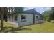 Back of the house with visible windows, chimney, external AC units, and chain-link fence at 1908 S Kingsway Rd, Seffner, FL 33584