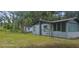 Shot of back of the house with visible windows, chimney, external AC units, and chain-link fence at 1908 S Kingsway Rd, Seffner, FL 33584