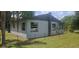 Back of the house with visible windows, chimney, external AC units, and chain-link fence at 1908 S Kingsway Rd, Seffner, FL 33584