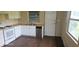 Renovated kitchen featuring dark floors, butcher block countertops, white cabinets and stainless dishwasher at 1908 S Kingsway Rd, Seffner, FL 33584