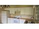 This kitchen features butcher block countertops, white appliances, and cabinets at 1908 S Kingsway Rd, Seffner, FL 33584