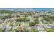 Expansive aerial view showcases a tranquil neighborhood with mature trees and waterfront access to beautiful waterways at 2025 Jefferson Ave, Dunedin, FL 34698