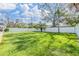 Spacious backyard featuring a well-maintained lawn and a tall privacy fence, offering a serene outdoor space at 2025 Jefferson Ave, Dunedin, FL 34698
