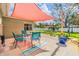 Outdoor patio with sunshade, seating, grill and manicured lawn at 2025 Jefferson Ave, Dunedin, FL 34698