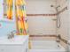 Bathroom with tile surround, decorative tile accents and shower-tub combination at 2025 Jefferson Ave, Dunedin, FL 34698