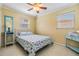 Bright bedroom featuring seashell bedding, ceiling fan, and natural light at 2025 Jefferson Ave, Dunedin, FL 34698