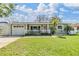 Charming single-story home with a well-manicured lawn, white picket fence, and inviting curb appeal at 2025 Jefferson Ave, Dunedin, FL 34698