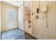 Hallway with bath access, neutral paint, and exterior door with glass panel at 2025 Jefferson Ave, Dunedin, FL 34698
