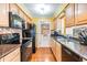 Charming kitchen with wood cabinets, granite countertops, colorful backsplash, and modern appliances at 2025 Jefferson Ave, Dunedin, FL 34698
