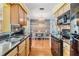 Modern kitchen with stainless steel sink, granite countertops, and black appliances that connect to the dining area at 2025 Jefferson Ave, Dunedin, FL 34698