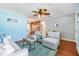 Open-concept living room with a view into the dining area, hardwood floors, and stylish decor at 2025 Jefferson Ave, Dunedin, FL 34698