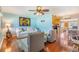 Inviting living room featuring hardwood floors, comfortable seating, and a seamless flow into the kitchen at 2025 Jefferson Ave, Dunedin, FL 34698