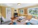 Bright living room with neutral decor, wood floors and plenty of sunlight at 2025 Jefferson Ave, Dunedin, FL 34698