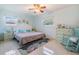 Serene main bedroom featuring a ceiling fan, windows and vintage furniture at 2025 Jefferson Ave, Dunedin, FL 34698