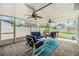 Enclosed porch with tile flooring and comfortable seating at 2025 Jefferson Ave, Dunedin, FL 34698