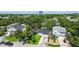 Aerial view of the property showcasing mature trees and landscaping, the roof, and surrounding neighborhood at 206 N Beverly Ave # 1/2, Tampa, FL 33609