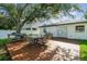 Backyard featuring a deck with outdoor dining set, ideal for entertaining guests at 206 N Beverly Ave # 1/2, Tampa, FL 33609