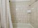 Shower featuring light tan tile surround and a shower curtain at 206 N Beverly Ave # 1/2, Tampa, FL 33609