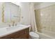 Bathroom featuring a decorative mirror, wood vanity, and shower with tub combo at 206 N Beverly Ave # 1/2, Tampa, FL 33609