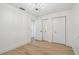 A bright bedroom features light floors, paneled walls, closet, and access to another room at 206 N Beverly Ave # 1/2, Tampa, FL 33609
