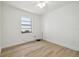 Bright bedroom with light wood flooring, white walls, and a ceiling fan at 206 N Beverly Ave # 1/2, Tampa, FL 33609