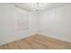 A well-lit bedroom with paneled walls and light wood floors at 206 N Beverly Ave # 1/2, Tampa, FL 33609