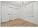 Bright bedroom featuring light wood flooring, paneled walls, and two storage closets at 206 N Beverly Ave # 1/2, Tampa, FL 33609