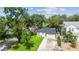 Charming single-story home with a well-manicured lawn, a driveway, and mature trees at 206 N Beverly Ave # 1/2, Tampa, FL 33609