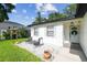 Inviting exterior with white stone, modern chairs and freshly cut lawn at 206 N Beverly Ave # 1/2, Tampa, FL 33609