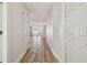 Hallway featuring wood-look tile flooring and white trim leading to an open living space at 206 N Beverly Ave # 1/2, Tampa, FL 33609